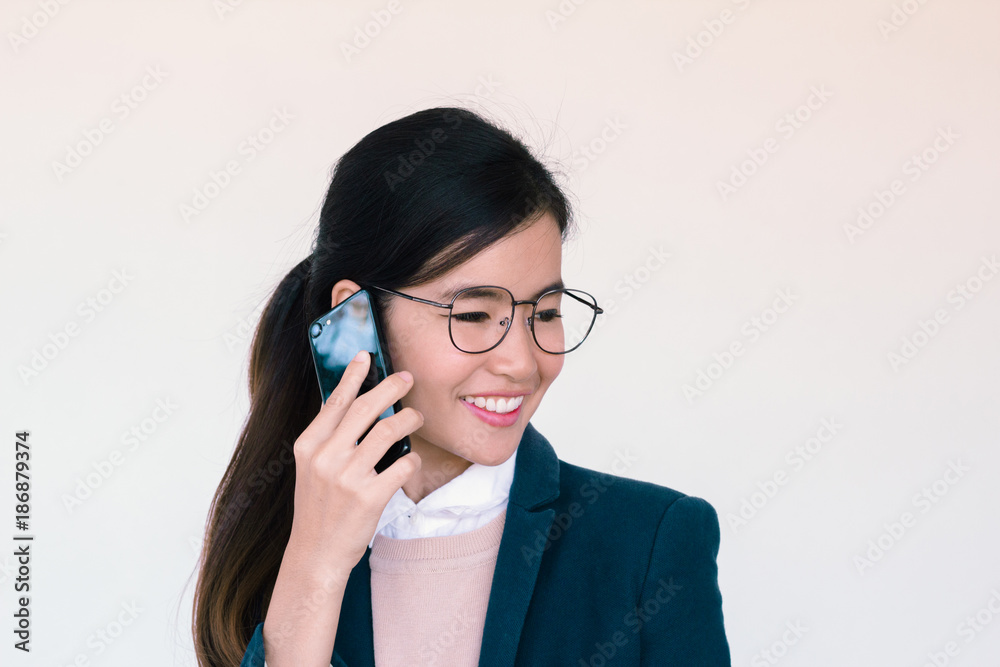 Young asian woman talking on her smartphone Young asian woman talking on her smartphone