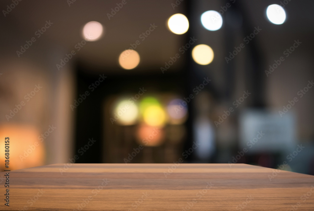 Empty wooden table and blurred background of abstract in front of restaurant or coffee shop for display of product or for montage Empty wooden table and blurred background of abstract in front of restaurant or coffee shop for display of product or for montage
