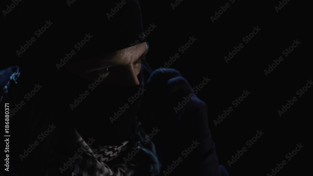 Close up of blackmailer demanding on smartphone in dark room Close up of blackmailer demanding on smartphone in dark room