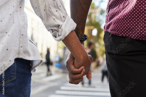 Close Up Of Couple Holding Hands On Urban Street