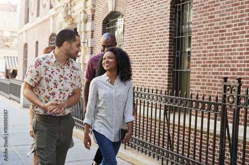 Group Of Friends Walking Along Urban Street In New York City