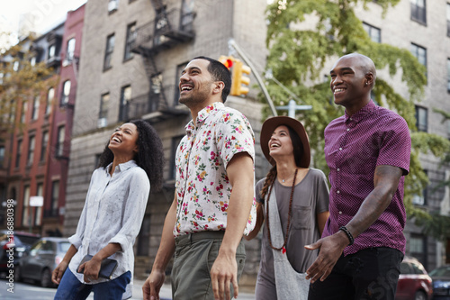 Group Of Friends Walking Along Urban Street In New York City