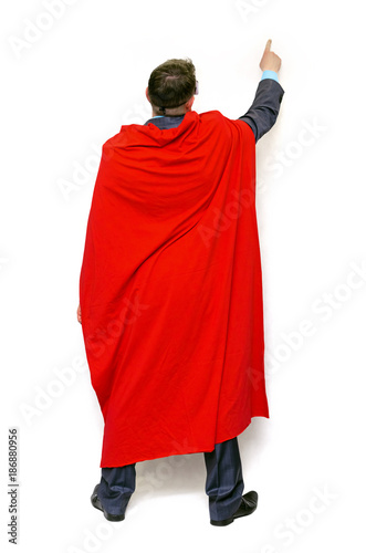 Super hero man showing by his index finger on copy space above him isolated on white background.