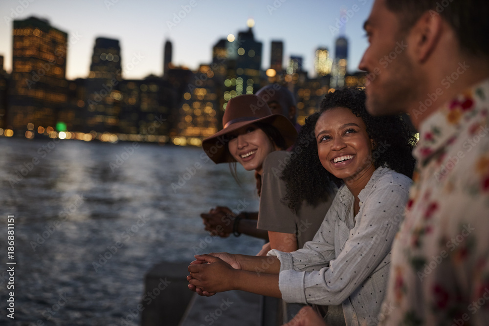 Fototapeta premium Group Of Young Friends On Trip To Manhattan At Dusk