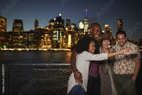 Group Of Friends Posing For Selfie In Front Of Manhattan Skyline