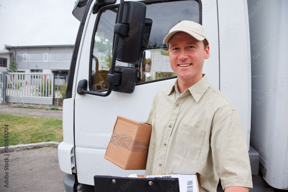 Delivery Boy Standing Next To A Truck Delivery Boy Standing Next To A Truck