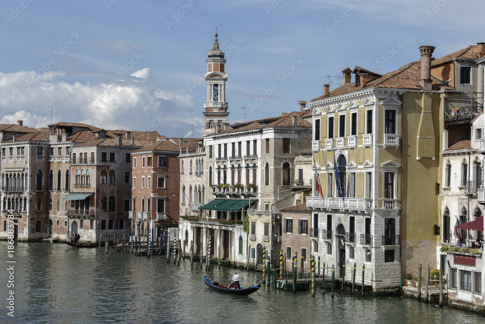 Naklejka premium Colorful facades of old medieval and historical houses along Grand Canal in Venice, Italy. Venice is situated across a group of 117 small islands that are separated by canals and linked by bridges
