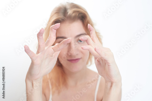 Hypermobility of the joints. The girl flexes the fingers on white background photo