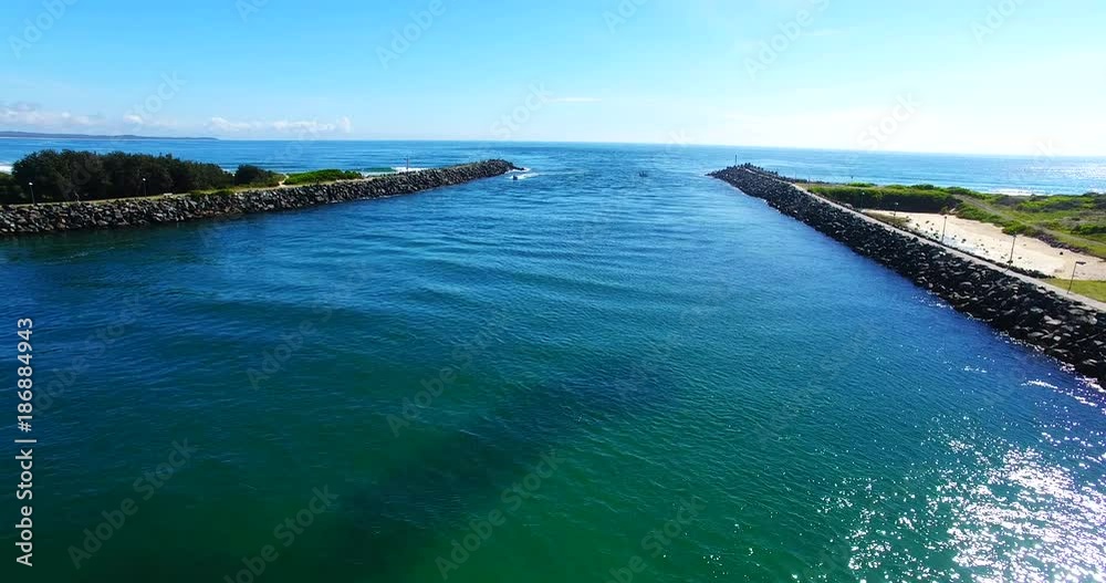 Boat enters harbor in Australia, aerial