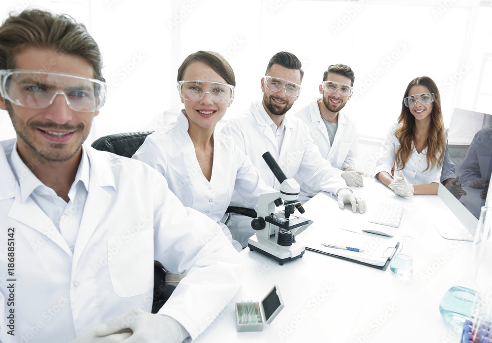 Male scientist and the team in the lab.