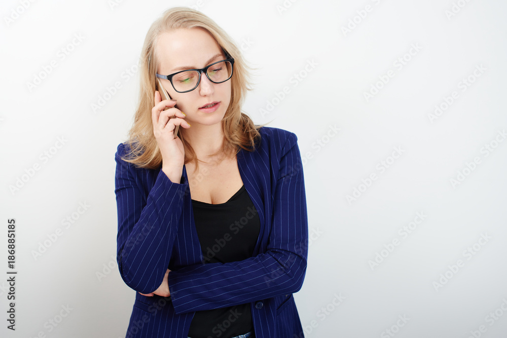 Business portrait. Blonde girl talking on the phone on white background