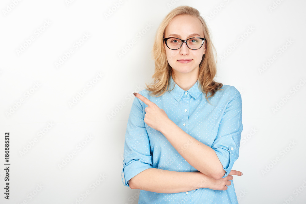 Business portrait. Girl on a white background pointing his finger Business portrait. Girl on a white background pointing his finger