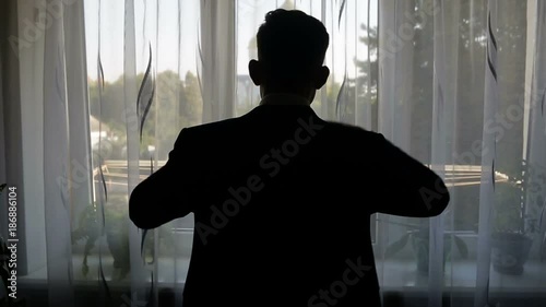 silhouette of a man dressed in the room