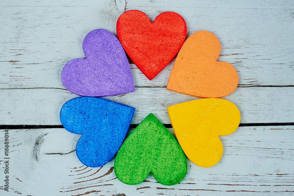 Obraz premium LGBT concept. Hearts rainbow colors lie on wooden background