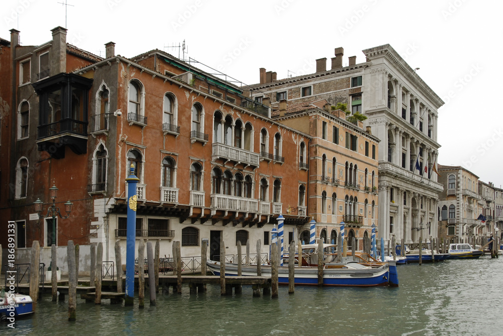 Colorful facades of old medieval and historical houses along Grand Canal in Venice, Italy. Venice is situated across a group of 117 small islands that are separated by canals and linked by bridges