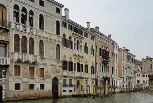 Colorful facades of old medieval and historical houses along Grand Canal in Venice, Italy. Venice is situated across a group of 117 small islands that are separated by canals and linked by bridges © LAURA