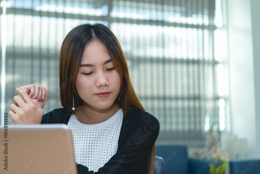 Beautiful asian woman working at the office in the evening,Thailand worker writing book in the company Beautiful asian woman working at the office in the evening,Thailand worker writing book in the company