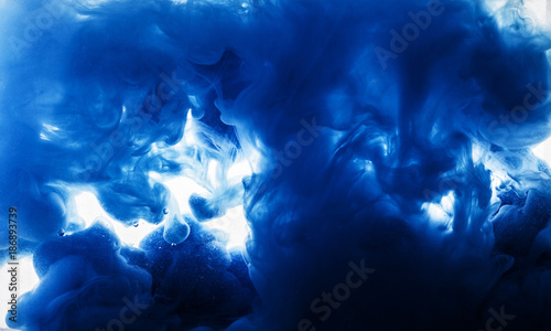 Macro photo of blue coracles in water of blue smoke clubs isolated on white background trendy abstract texture background with place for text