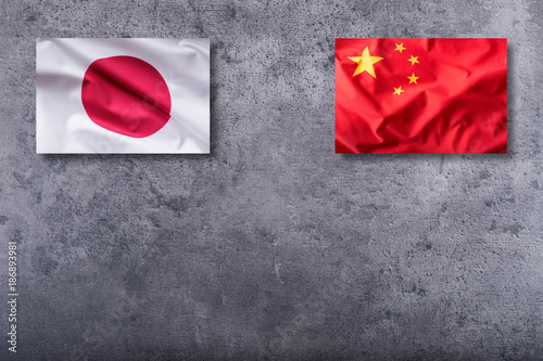 China and Japan flags. China and Japan flag on concrete background