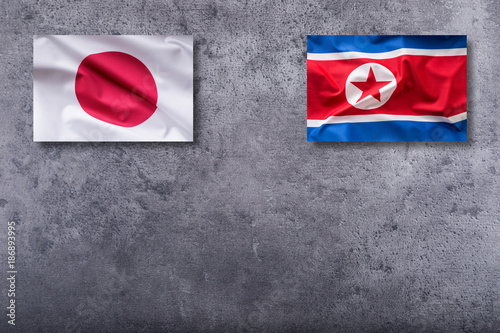 North Korea and Japan flags. North Korea and Japan flag on concrete background