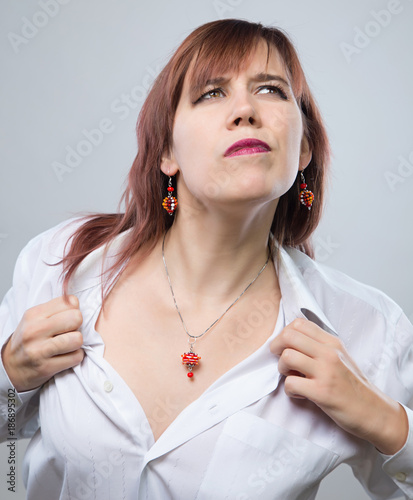 Young woman showing neckline photo