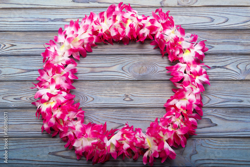 Hawaiian wreath on a wooden background.