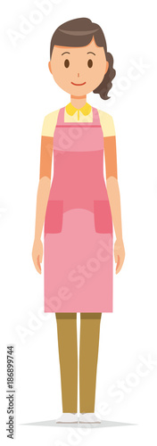 A female home helper wearing an apron stands up