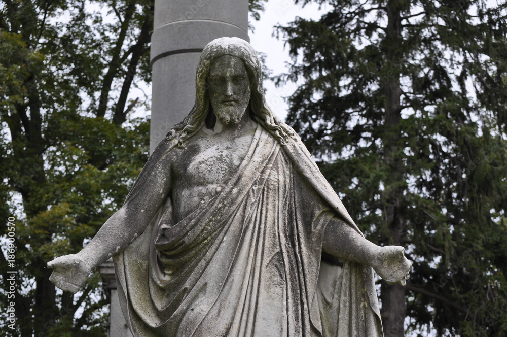 Statue of Jesus Looking Down Upon a Grave Statue of Jesus Looking Down Upon a Grave