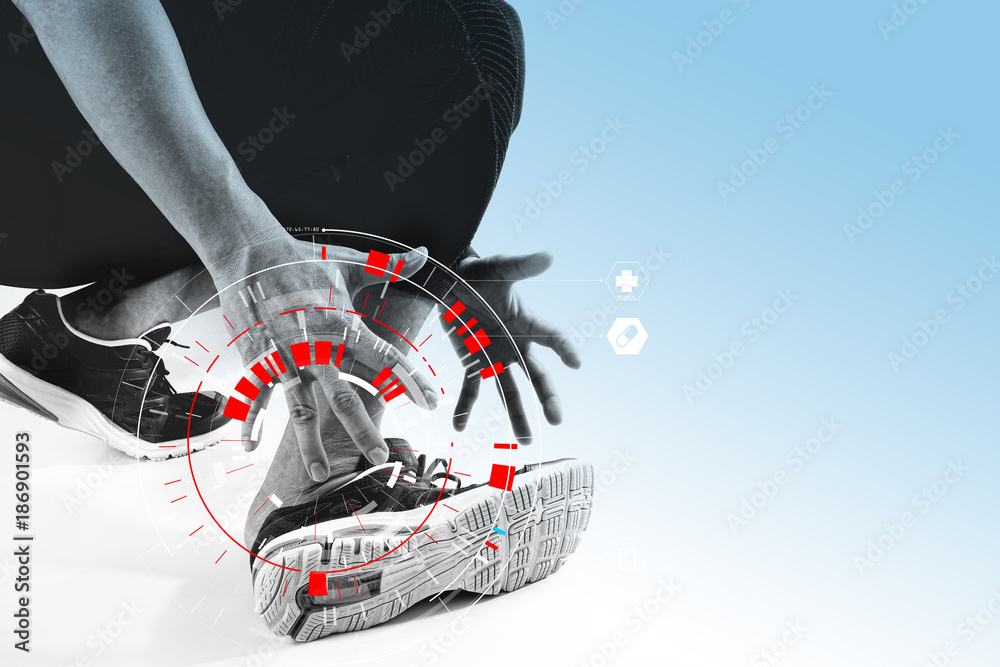 Athletic man touching foot due to sprain with VR medical scanning Athletic man touching foot due to sprain with VR medical scanning
