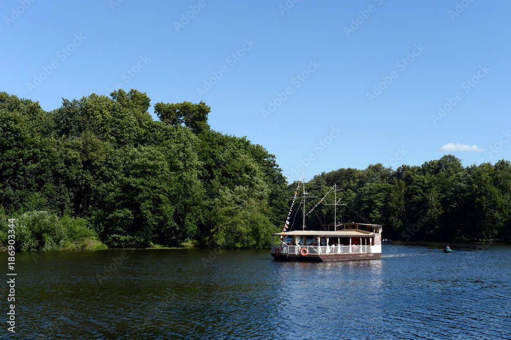 Pleasure boat on a pond in the natural-historical park 