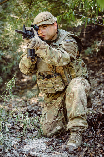 Army sniper during the military operation in the mountain. war, army, technology and people concept.