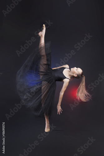 Fototapeta Naklejka Na Ścianę i Meble -  Rhythmic gymnastics. Gymnast girl balancing on one leg doing a vertical split