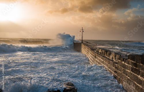 Coastal Storm, 01/01/2018 Cornwall, UK. Porthleven harbour fighting stormy weather as the sun breaks through