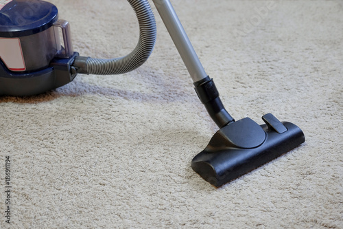 Wallpaper Mural Cleaning the carpet using a vacuum cleaner. Torontodigital.ca