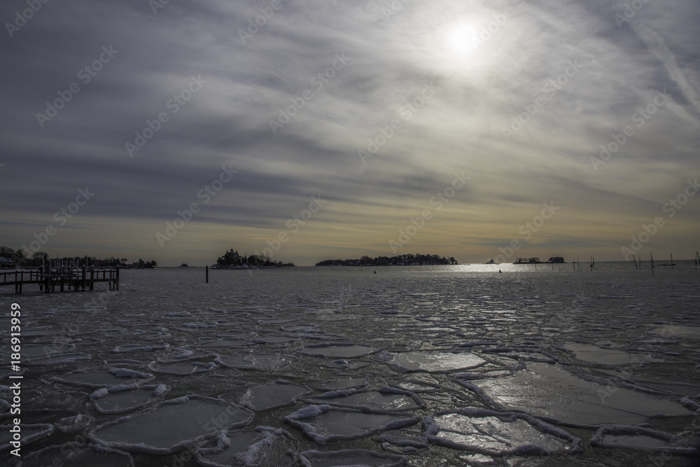 Low Sun on Frozen Sea on Long Island sound in Winter Cold