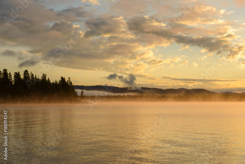 Morning Misty Lake - Colorful clouds and morning fog over Yellowstone Lake  Yellowstone National Park  Wyoming  USA.