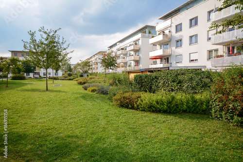 New apartment building, modern residential development with outdoor facilities in a green urban settlement © ah_fotobox