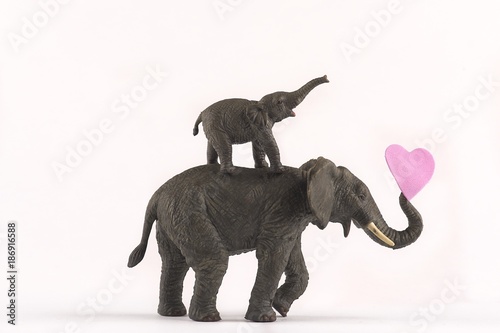 Sticker elephants in love on white background with hearts and family for valentines day