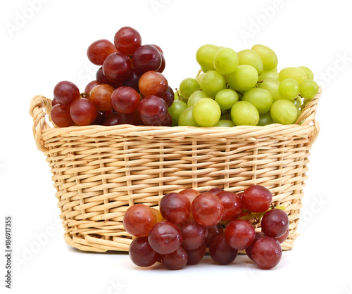 Fresh red and green grapes in basket Isolated on white