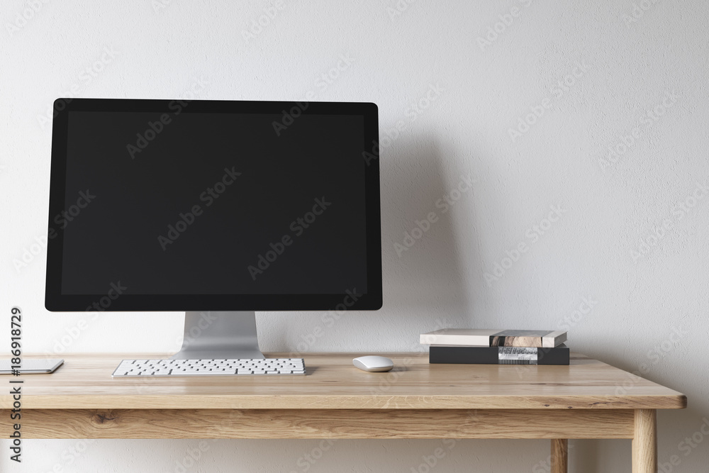 Blank computer screen on a wooden desk Blank computer screen on a wooden desk