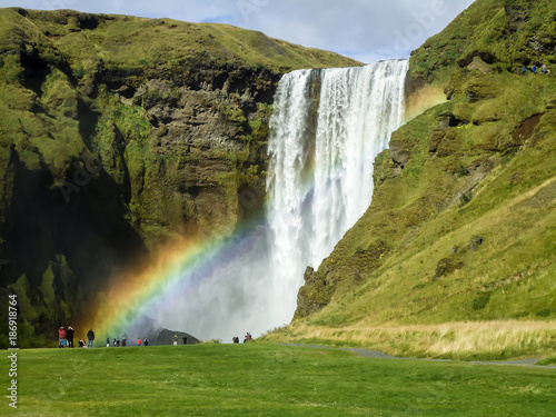 Waterfall with rainbow. Magical landscape Iceland
