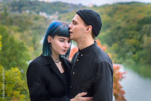 girl and boyfriend lovers near the river in the fall