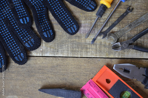 Top view of Working tools,wrench,socket wrench,hammer,screwdriver,plier,electric drill,tape measure,machinist square on wooden board. flat lay design. photo