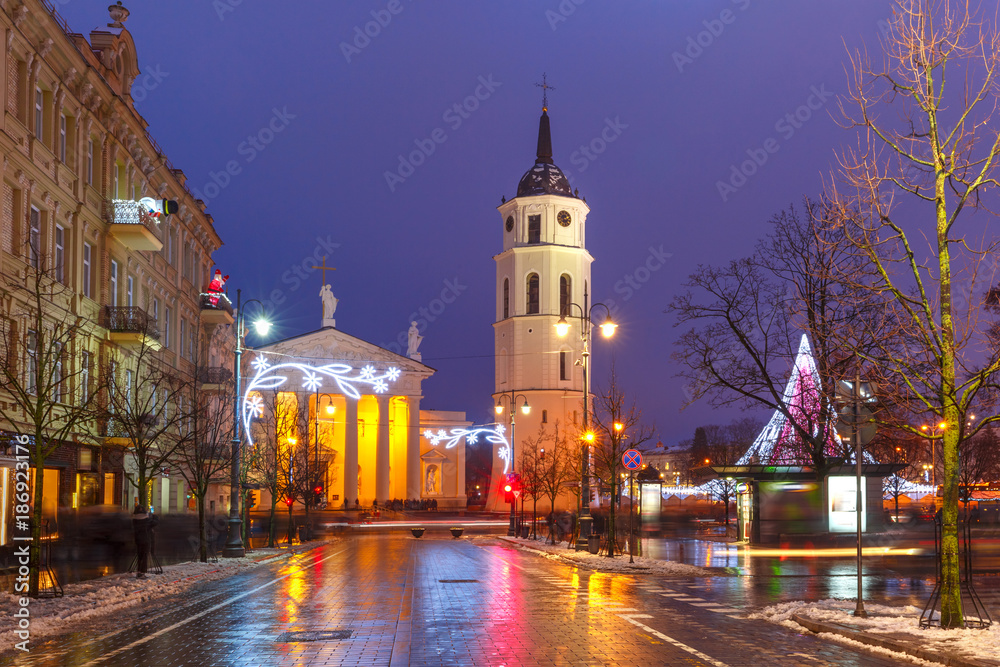 Decorated and illuminated Christmas Gediminas prospect and Cathedral Belfry during evening blue hour, Vilnius, Lithuania, Baltic states.