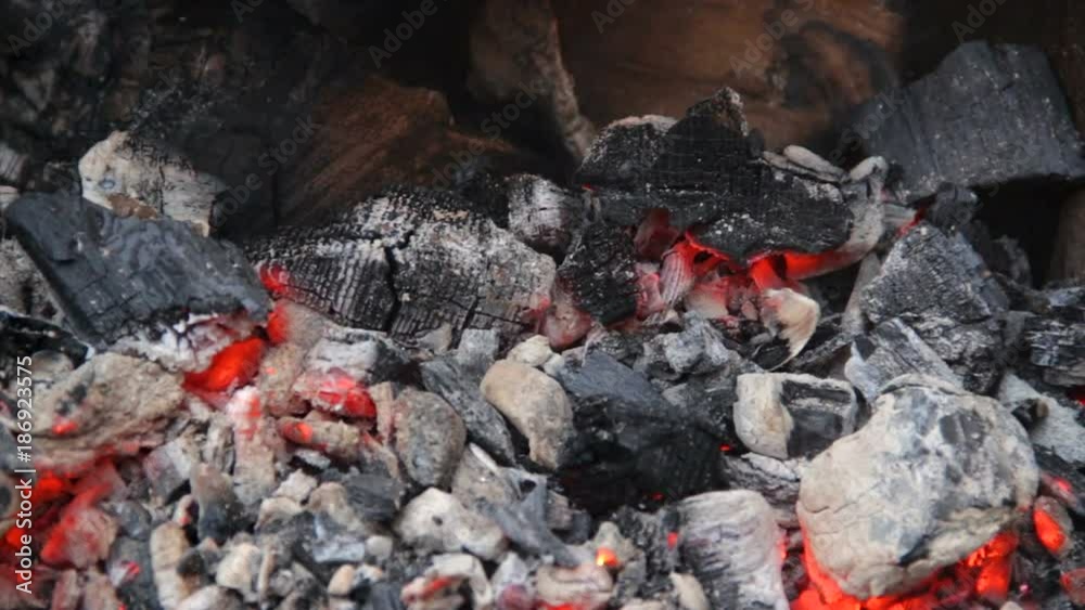 Red hot charcoal slowly glowing in big barbecue brazier, arson fire remains Red hot charcoal slowly glowing in big barbecue brazier, arson fire remains
