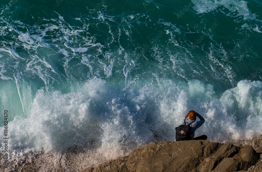 Naklejka premium Girl photographing waves