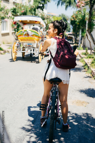 Woman riding on bike,phaeton with horses,sports summer