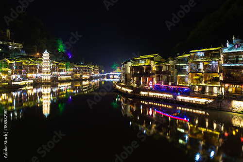 Night view of Fenghuang Ancient town, Hunan province, China. This ancient town was added to the UNESCO World Heritage Tentative List in the Cultural category.