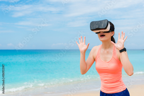 beautiful fitness lady using virtual reality