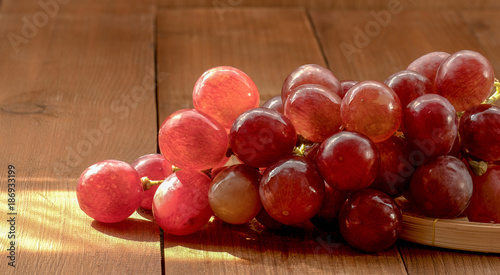 Photography The closeup of red grapes on a wooden table